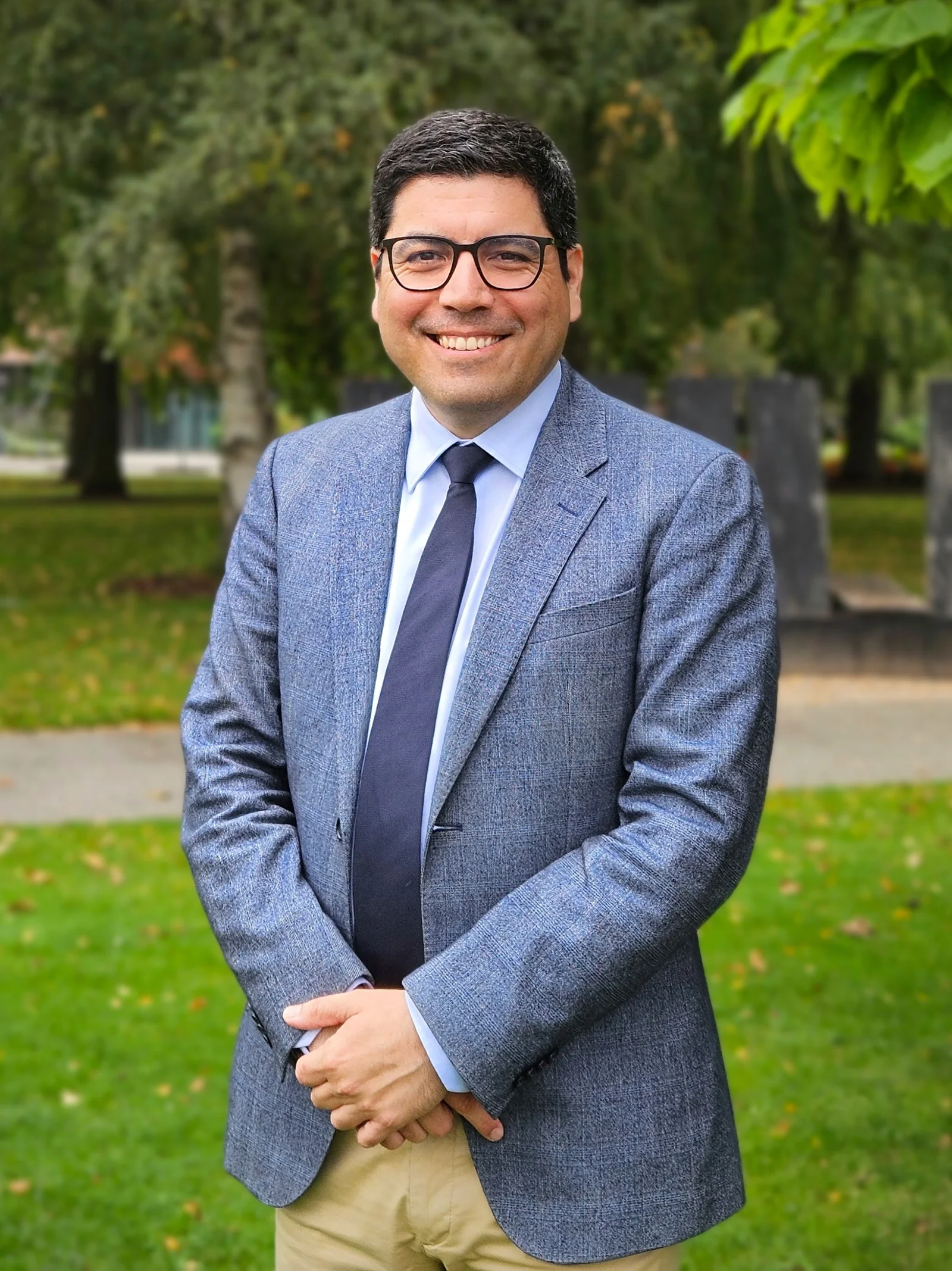 Hernan Caceres wearing a jacket and tie, outdoors